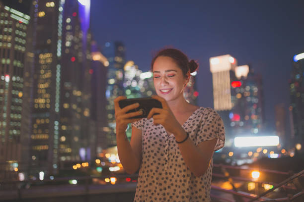 istock Girl Uses Phone Outdoors 1056619996