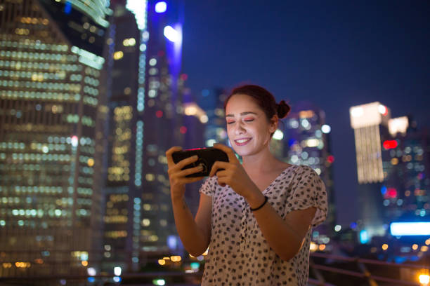 istock Girl Uses Phone Outdoors 1056620448