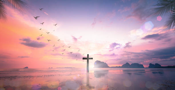 The cross at autumn background Resurrection of Jesus Christ concept: Silhouette cross on beach autumn sunrise background holy week photos stock pictures, royalty-free photos & images