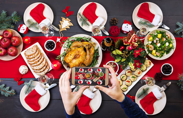 istock Baked turkey. Christmas dinner. The Christmas table is served with a turkey, decorated with bright tinsel and candles. Fried chicken, table.  Family dinner. Top view 1056620596
