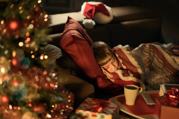 istock Cute boy waiting for Santa and sleeping on the sofa 1056620646
