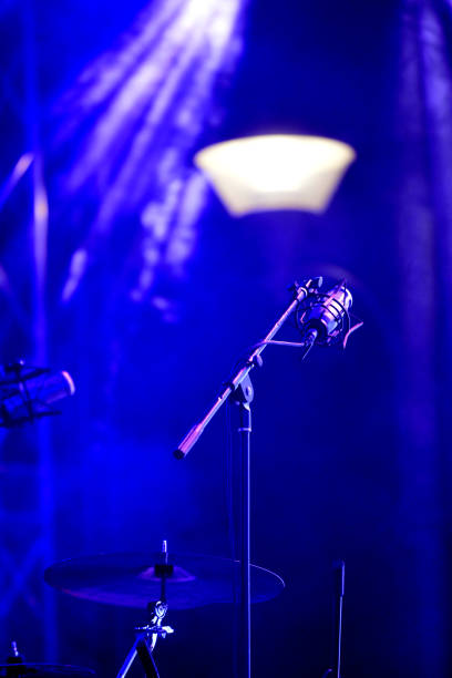 istock microphone on a rock concert, blue light show 1056625982