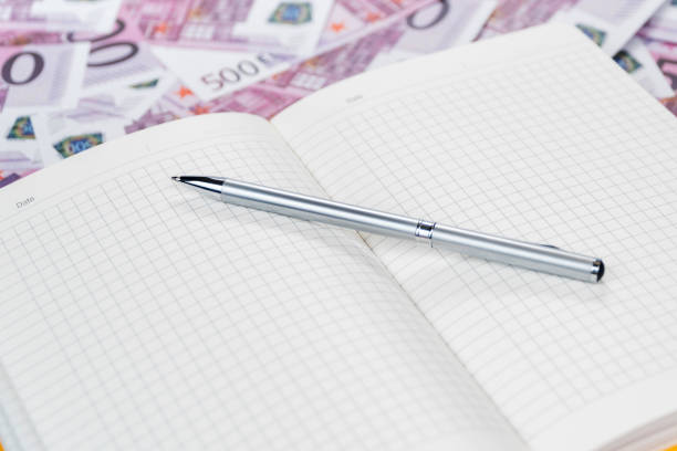 istock Diary with a pen on the money 1056628378