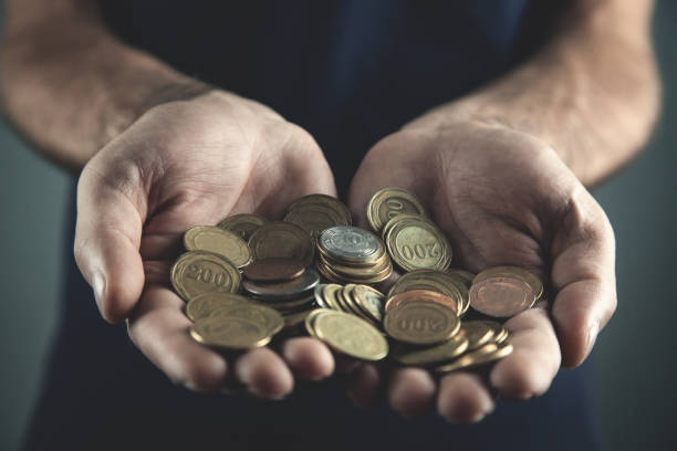istock Human hands holding coins. Saving and investment concept 1056628440