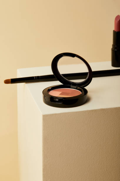 istock close-up shot of blush can with lipstick and applicator on beige cube 1056628894