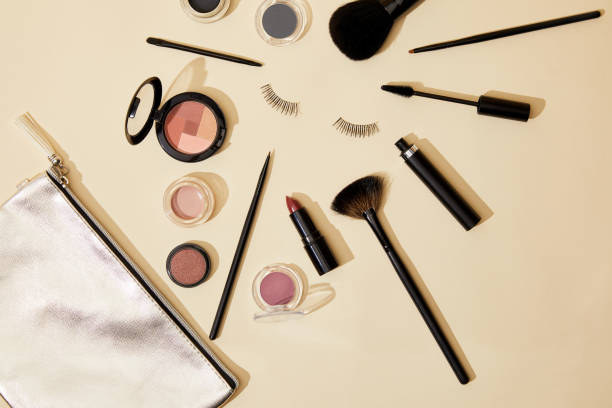 istock top view of various cosmetics lying on beige surface around false eyelashes 1056628946