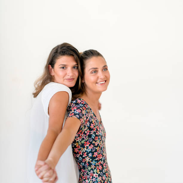 istock Happy lesbian couple standing while holding hands 1056631398