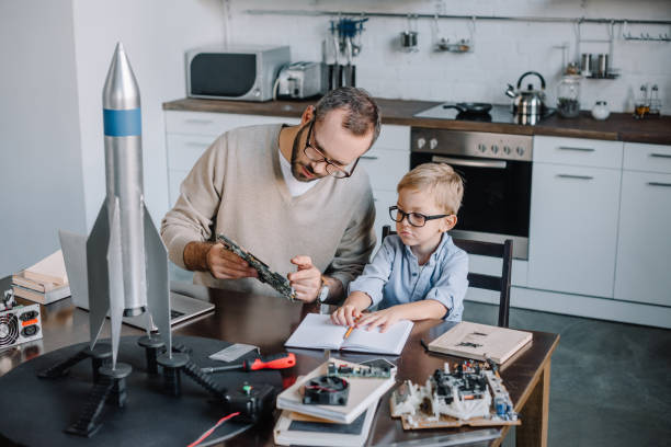 istock father and son repairing microcircuit at home 1056632308