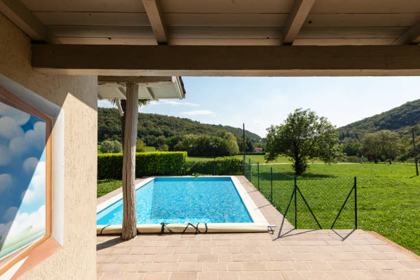 istock Villa with pool and surrounded by green lawn on a summer day 1056632318