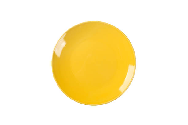 istock Empty yellow ceramic round plate isolated on white background. Top view 1056632376