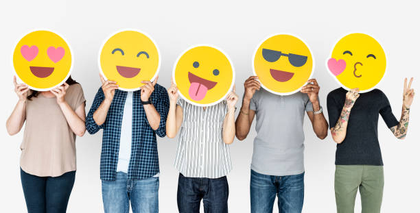 istock Diverse people holding happy emoticons 1056635278