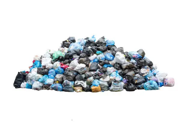 Photo of Big pile of garbage in black blue trash bags isolated on white background. Ecology concept. Pollution environment disaster