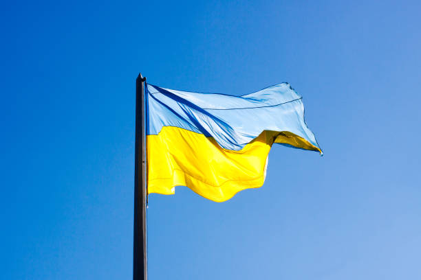 istock Ukrainian country flag on blue sky background. Sunny. 1056636318