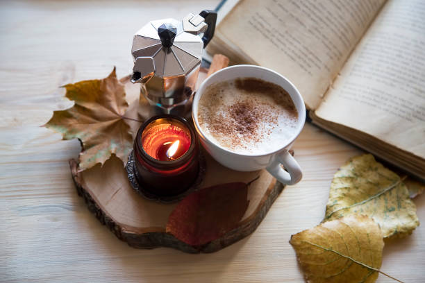 istock Autumn composition with coffee, scented candle , dried leaves and a book 1056641128