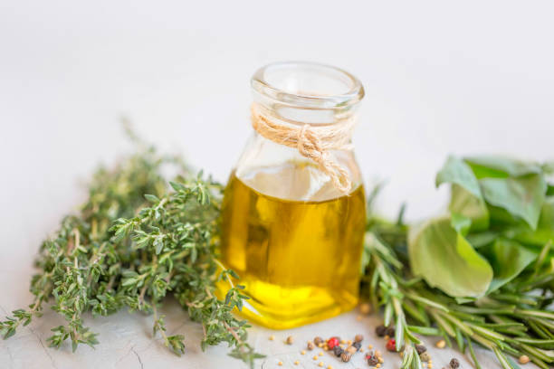 istock Cooking olive oil bottle with herbs and spices 1056641204