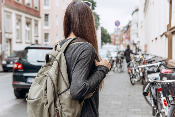 istock Tourist with a backpack is looking for booked online accommodation in an unfamiliar city. 1056641396