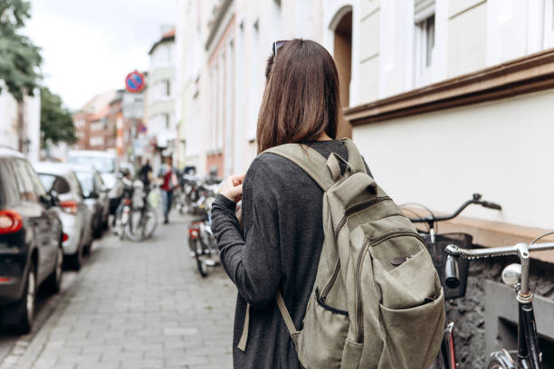 istock Tourist with a backpack is looking for booked online accommodation in an unfamiliar city. 1056641404