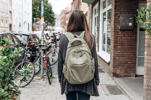 istock Tourist with a backpack is looking for booked online accommodation in an unfamiliar city. 1056641438