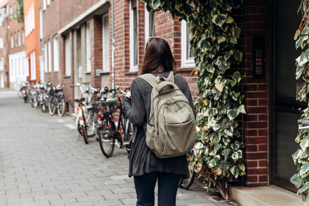 turista com uma mochila está à procura de alojamento on-line reservado em uma cidade estranha. - booked - fotografias e filmes do acervo