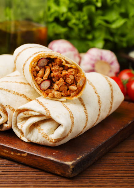 istock Burritos wraps with meat, beans and vegetables. 1056641830