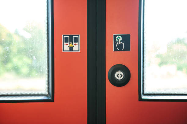 The exit door of the train Close-up. The exit door of the train with a button to automatically open the door on demand when the train stops. railway signal stock pictures, royalty-free photos & images