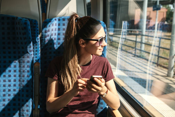 istock A tourist on the train uses a mobile phone. 1056641888