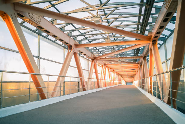 istock Modern metal bridge construction. Pedestrian crossing over a highway 1056644430