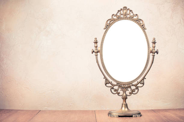 istock Old vintage bronze makeup mirror frame on table. Retro style filtered photo 1056646420