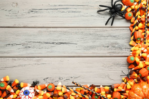 istock Halloween candy corns and pumpkins on wooden table 1056646462