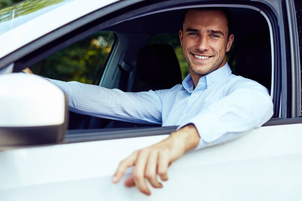 istock Smiling man sitting in his car 1056649870