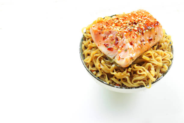 healthy bowl of grilled salmon with oriental noodles with copy space