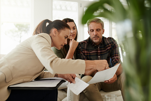 Shot of a mature couple getting advice from their financial consultant at home