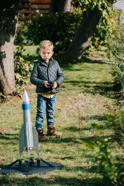 cute little boy launching model rocket outdoor cute little boy launching model rocket outdoor model rocket stock pictures, royalty-free photos & images