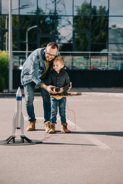 istock happy father and son launching model rocket outdoor 1056656386
