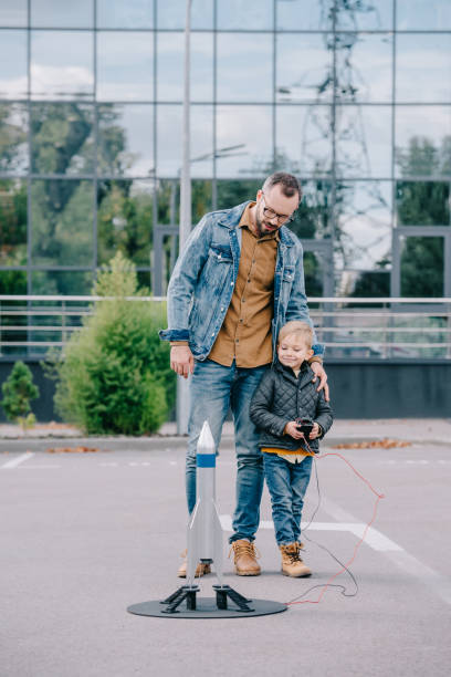 istock happy father and little son launching model rocket outdoor 1056656390