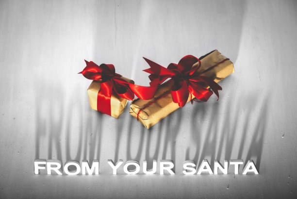 istock SANTA IS COMING writing and a red bow 1056657388