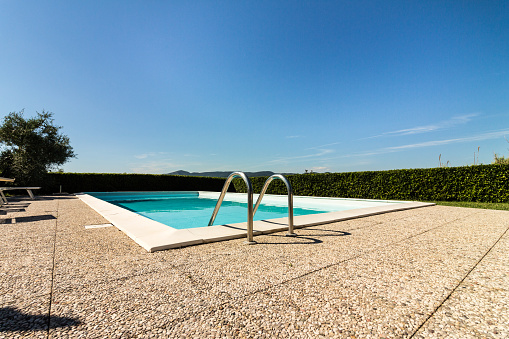 Empty pool in front of a blue sky
