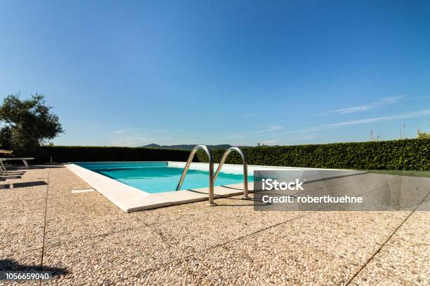 Swimmingpool In Front Of A Blue Sky Stock Photo - Download Image Now - Deck Chair, Swimming Pool, Backgrounds