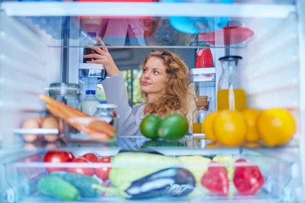 istock Woman taking food from fridge. 1056659200