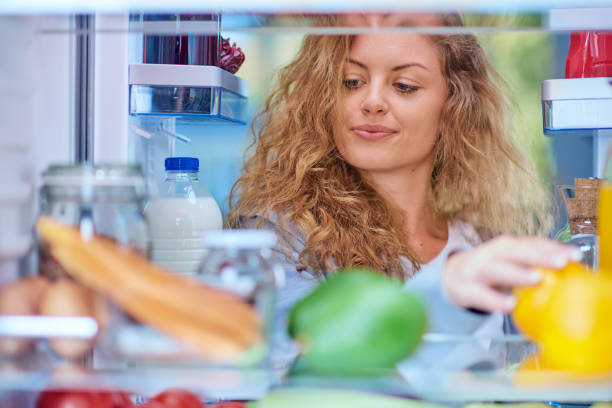 istock Woman taking food from fridge. 1056659388