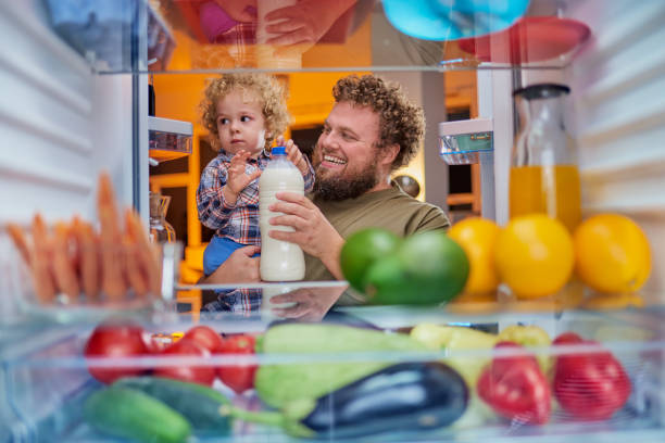 istock Father and son taking milk from fridge in late hours. 1056662458