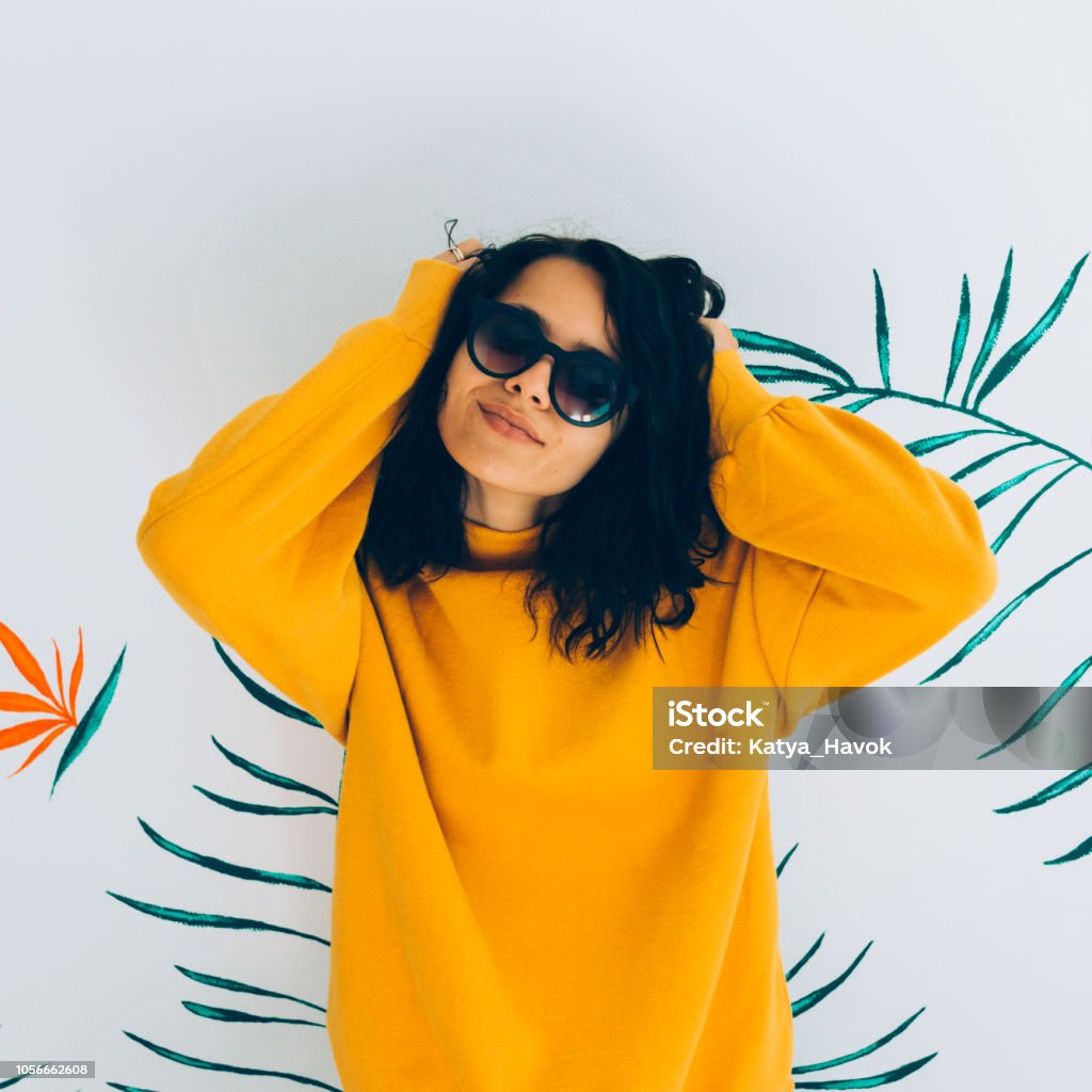 Beautiful and fashionable woman Beautiful and fashionable woman in accessories and sweatshirt. Stylish Hoody yellow trendy vibes Sweatshirt Stock Photo