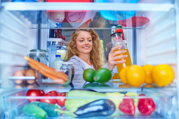 istock Woman taking juice from fridge. 1056662662