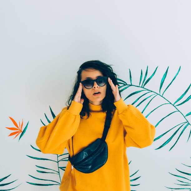 Beautiful woman in sunglasses, belt bag and sweatshirt. stock photo