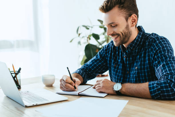 istock smiling businessman taking part in webinar at tabletop with laptop in office 1056663220