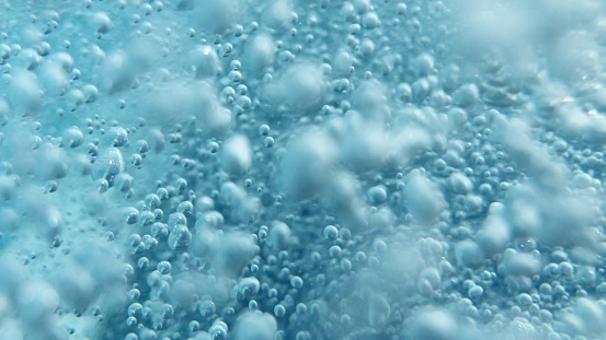 Close up shot of air bubbles taken underwater symbolising the essence of life and the universe. A great background to use for science and technology themes.