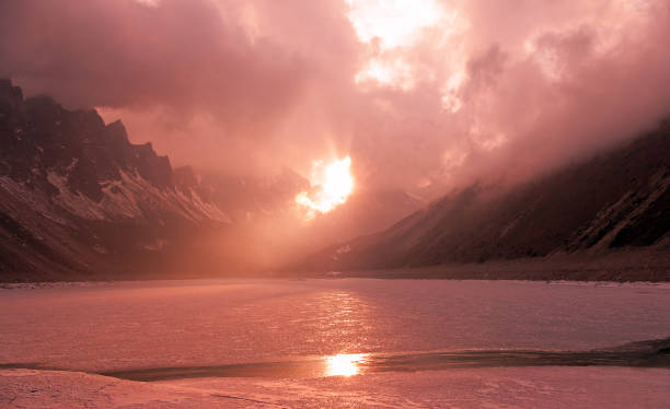 istock Frosen Lake Sun Ray Clouds 1056665874
