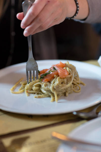istock Woman Eating Creamy Pasta with Salmon 1056665934