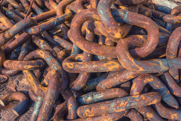 istock Rusty tangled chains lie in the port. Background. Metal corrosion 1056668964