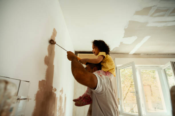 Beautiful home for beautiful family Young family renovating their home, painting wall renovation photos stock pictures, royalty-free photos & images